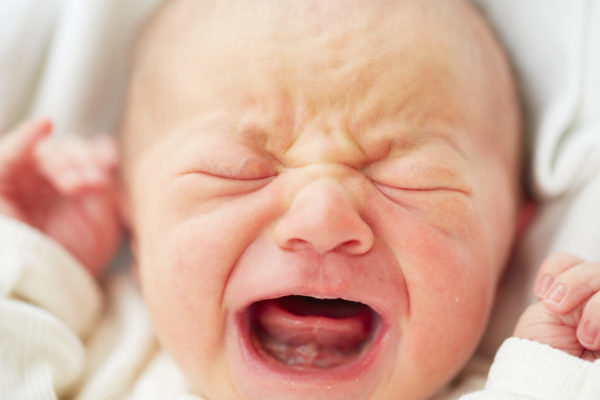 Image of a baby with a tongue tie crying