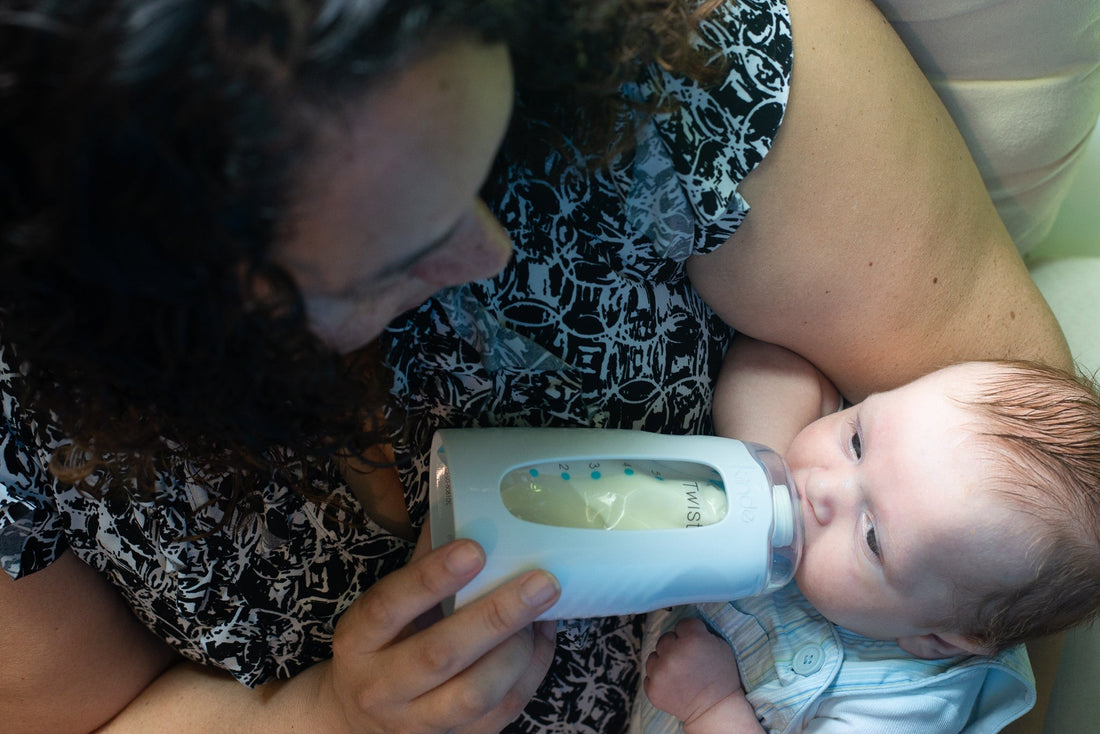 A mom feeding a baby with a Kiinde Squeeze Bottle