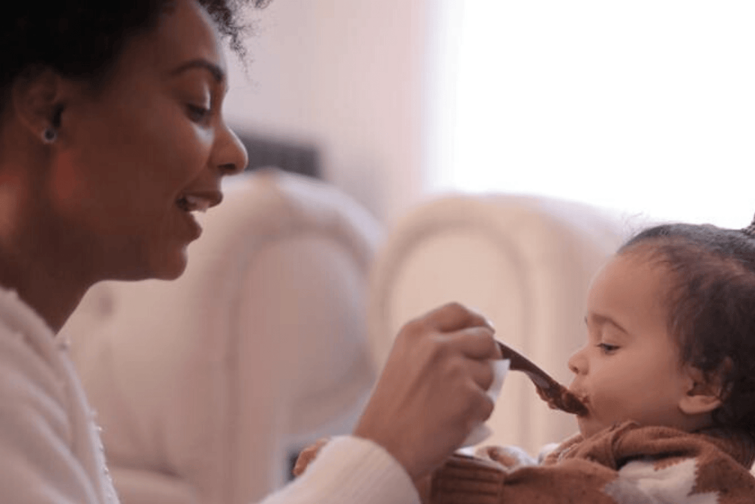 Mom feeding her baby with a spoon