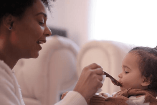 Mom feeding her baby with a spoon