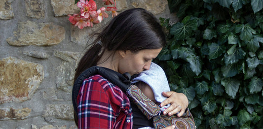 An image of a mother babywearing her baby