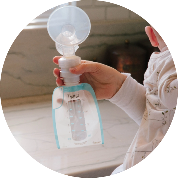 Mom Holding Kiinde Breast Milk Bag with Breast Pump Adapter